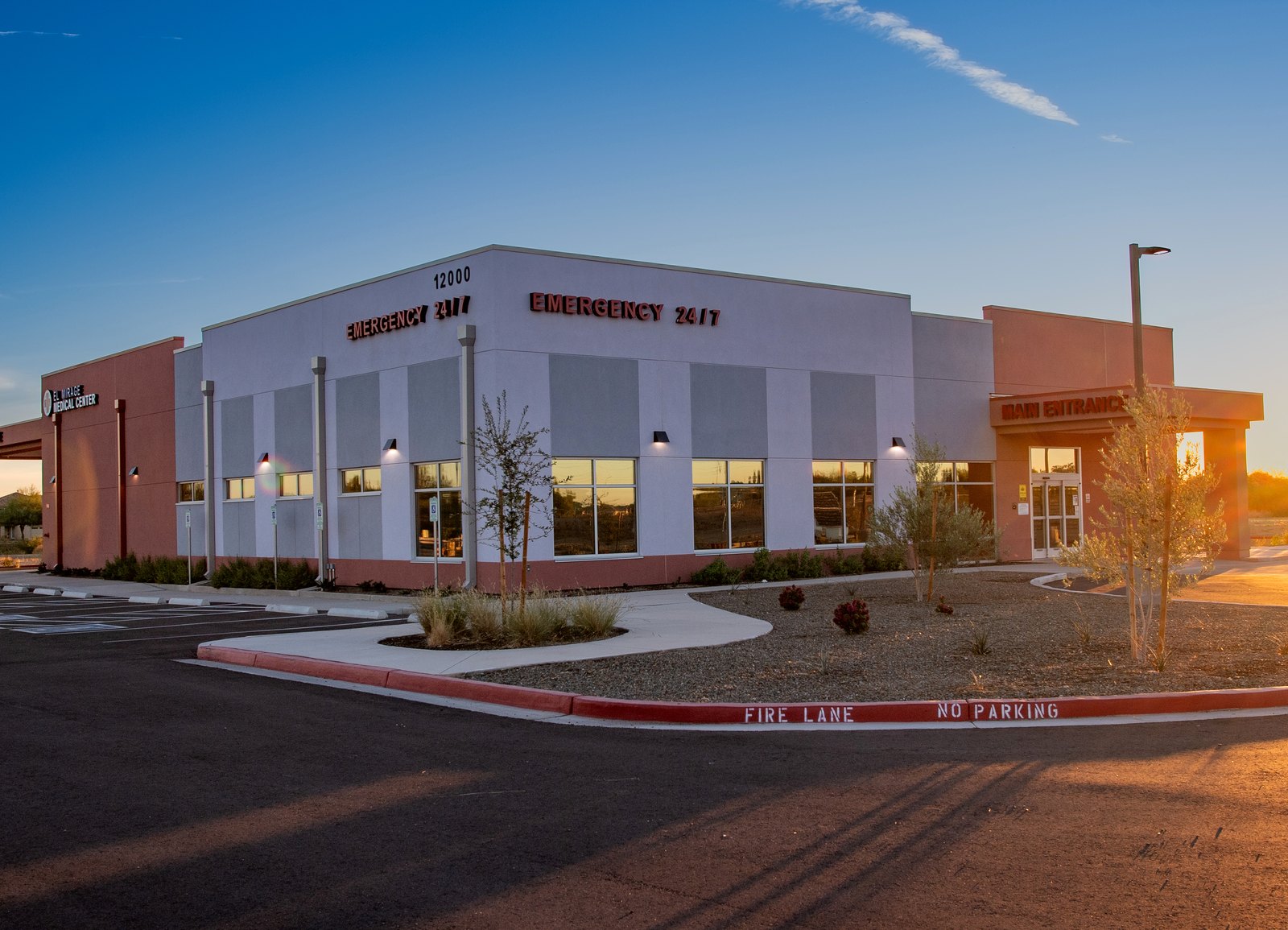 The El Mirage Emergency Room building at dusk, EMERGENCY 24/7 lit on the parapet.